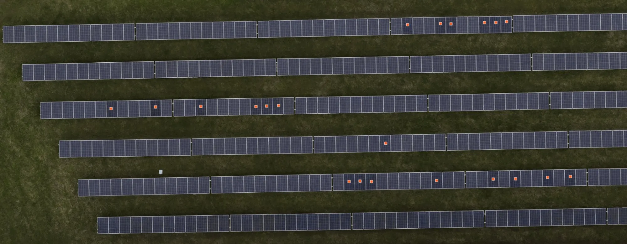Wide aerial view of the solar array with markers showing detected mismatched modules