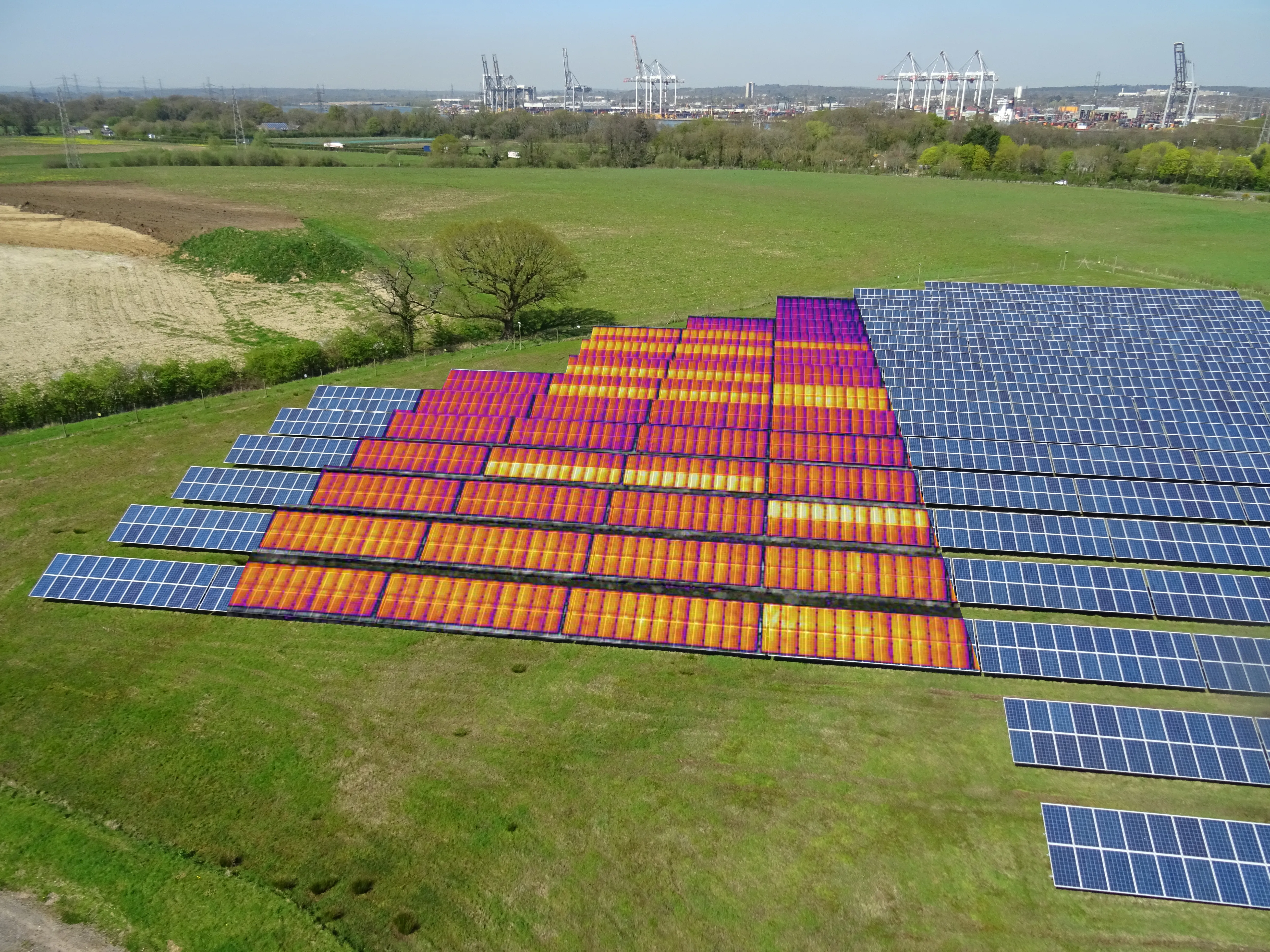 Thermal inspection overlay on solar farm showing hotspot detection